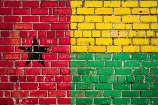 National flag of the Guinea Bissau on a grunge brick background. - Powered by Adobe