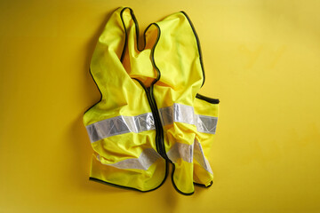 yellow reflective vest against yellow background - Powered by Adobe