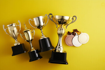 gold trophy against yellow background