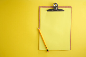 clipboard against yellow background  with copy space