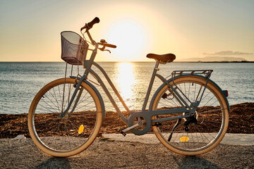Bicycle parked on the seaside promenade on beach, vacation in summer.
