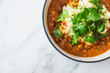 healthy plant-based food, vegan lentil and beans curry with coconut jasmine rice and coriander