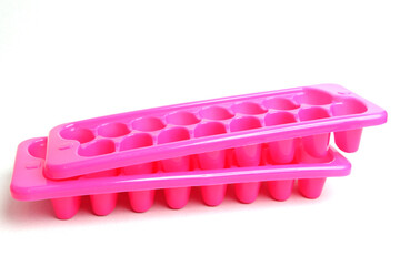Plastic pink mold for ice. Refrigeration of drinks.