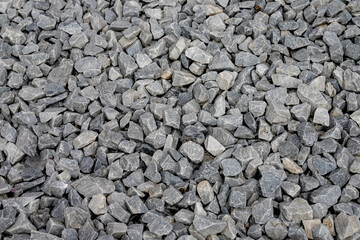 Selective focus of black pebble pattern, Dark grey gravel surface, Natural stone floor in the garden, Rock material texture, Abstract background.