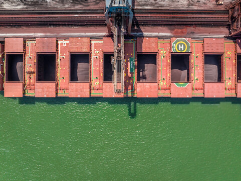 Bulk Carrier Ship Offloading Cargo By Crane for Processing