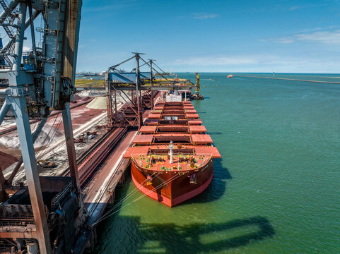 Bulk Carrier Ship Offloading Cargo By Crane for Processing