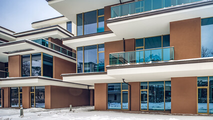 Modern exterior of new luxury residential building at winter.