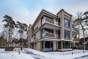 Modern exterior of new luxury residential building at winter.