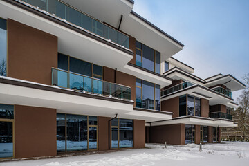 Modern exterior of new luxury residential building at winter.