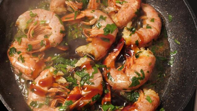 Cooking big shrimps on frying pan. Preporation langoustines. Closeup. Top view