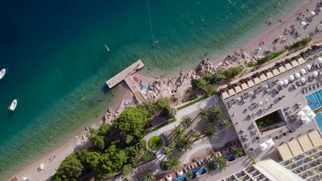 Drone 4k vertical view of the sea coast with hotel at the shore