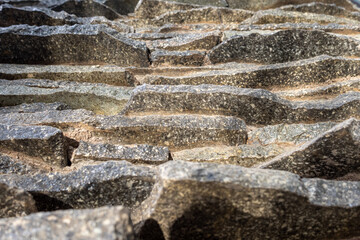 An abstract close up vertical view of a flat rocks stack, that is assembled as a simulation of natural decoration.
