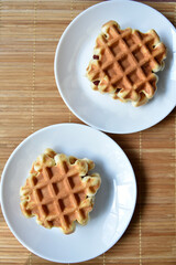 Viennese waffles on a white plate. Delicious waffles for breakfast.