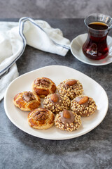 Almond and walnut cookies. Assortment of sweet cookies on dark background. Bakery products. Vertical view. Close-up.