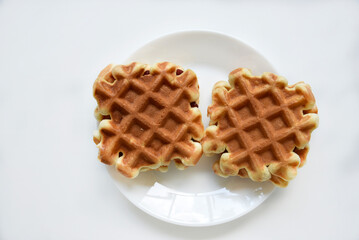 Viennese waffles on a white plate. Delicious waffles for breakfast.