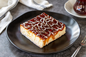 Trilece dessert. Slice of dessert with caramel and milk on a dark background. Bakery products. side view. Close-up.