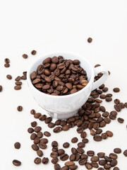 Coffee beans in cup on white background. Roasted ground coffee