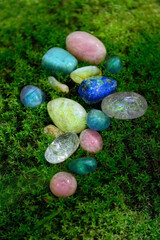 gemstones close up on moss, dark natural background. set of colorful minerals for esoteric Magic crystal Ritual, Witchcraft, spiritual practice. healing stone therapy for life balance, soul relax