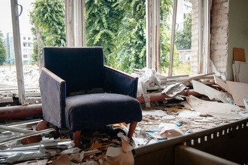 an old armchair in a war-damaged school