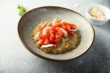 Healthy quinoa porridge with fresh strawberry