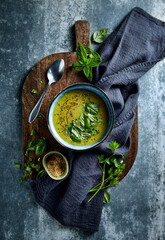 Cream of green vegetable soup with herbs (seen from above). Healthy homemade food