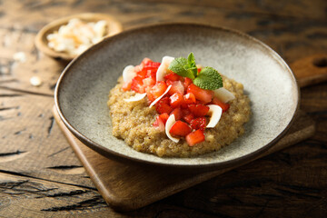 Healthy quinoa porridge with fresh strawberry