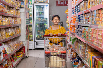 Kids girl shopping at supermarket