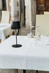 outdoor table and chairs in a restaurant in Venice, Italy 