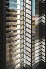 shadow of blinds over a window