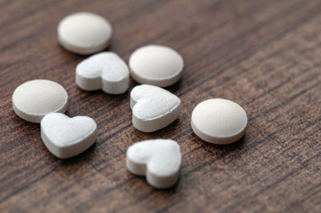 White pills in the shape of a heart