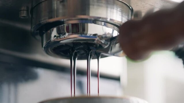 Close-up of coffee dripping from filter into cup, professional coffee brewingClose-up of aromatic drink pouring into a cup