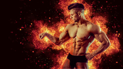 Brutal strong athletic Bodybuilder posing. Fire and spark explosion in the background.