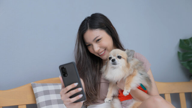 Holiday concept of 4k Resolution. Asian girls playing cell phones in the bedroom. Take a picture with a smartphone.