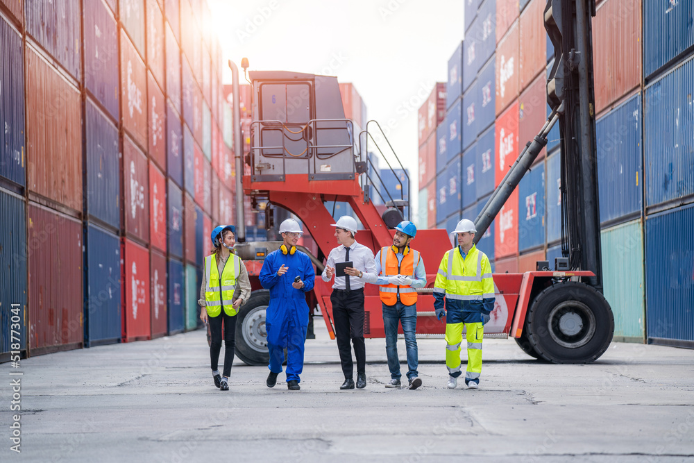 Poster manager and cargo container worker having discussion on working plan together in the container yard,