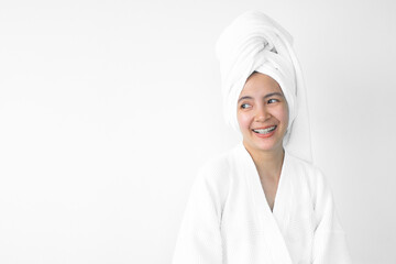 Beautiful Asian woman wearing bathrobe on white background, Face care, Skin care, Facial treatment, Cosmetology, beauty and spa Concept.