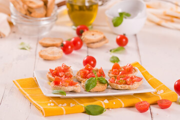 Friselle with cherry tomatoes and basil.