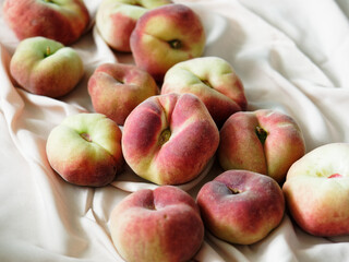 closeup of peaches on light silk background