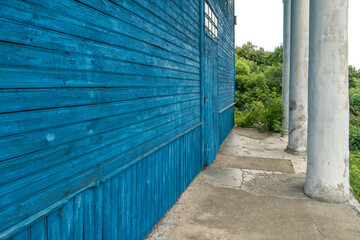 An old wooden building with columns. Restoration of a historic building.