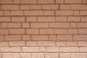 A pale orange brick wall neatly arranged in a horizontal manner