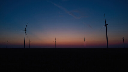 Windmill farm park and turbines for producing green electricity.