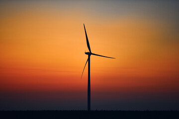 Windmill farm park in silhouettes with colorful sky.