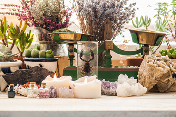 Cozy space with candles, crystals, herbs, and plants. Alternative medicine, herbal medicine,...