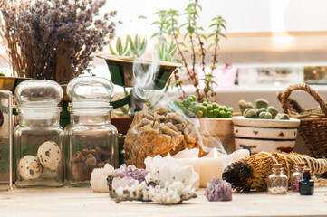 Cozy space with candles, crystals, herbs, and plants. Alternative medicine, herbal medicine,...