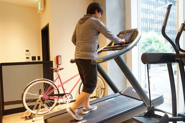 Fototapeta na wymiar Overweight Fitness Man Running on a Treadmill at Gym, Fat fitness men exercising at fitness gym. Man diet lifestyle concept to reduce belly - 運動をする男性 バイクエクササイズ