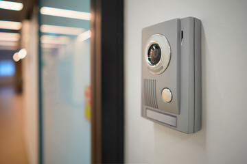 Video intercom system on white wall to enter office. Intercum with a camera in the office. New...