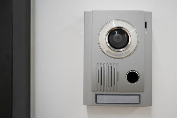 Video intercom system on white wall to enter office. Intercum with a camera in the office. New...