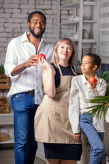Happy family cooking breakfast or lunch on kitchen at home. African American man and her wife, son preparing. Family communicating, culinary and enjoying weekend time