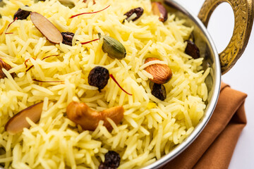 Kashmiri sweet modur pulao made of rice cooked with sugar, water flavored with Saffron and dry...