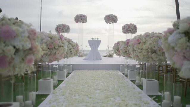 Panorama wedding reception at the beach. Wedding detail colorful flowers pattern decor beach.