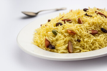 Kashmiri sweet modur pulao made of rice cooked with sugar, water flavored with Saffron and dry...